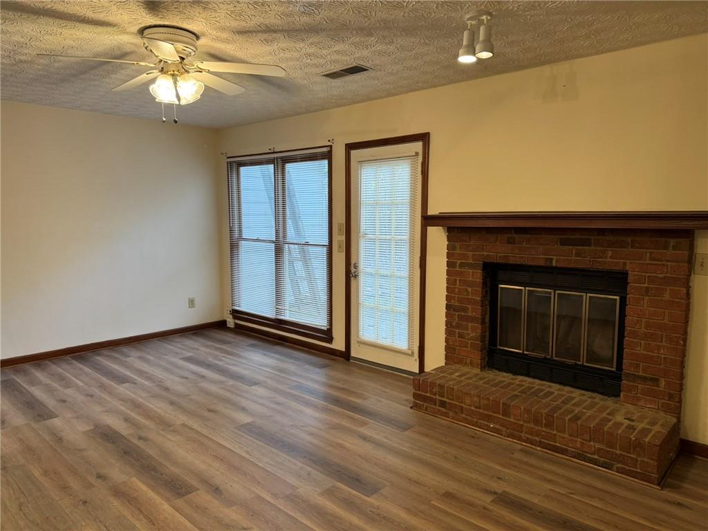 1105 Booth Court Southwest, Unit 1105 Marietta, GA 30008 - Photo 8 of 28 a view of a livingroom with a fireplace and wooden floor