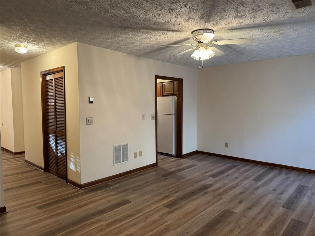 1105 Booth Court Southwest, Unit 1105 Marietta, GA 30008 - Photo 9 of 28 a view of an empty room with wooden floor