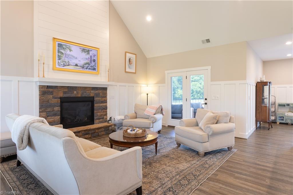 393 Scout Road Lexington, NC 27292 - Photo 6 of 47 Enter through the front door, turn to the left and take in the beauty of this wonderful space. The great room boasts vaulted ceilings and gorgeous wainscoting. This space opens onto the screened porch, perfect for enjoying crisp mornings or cool evenings.