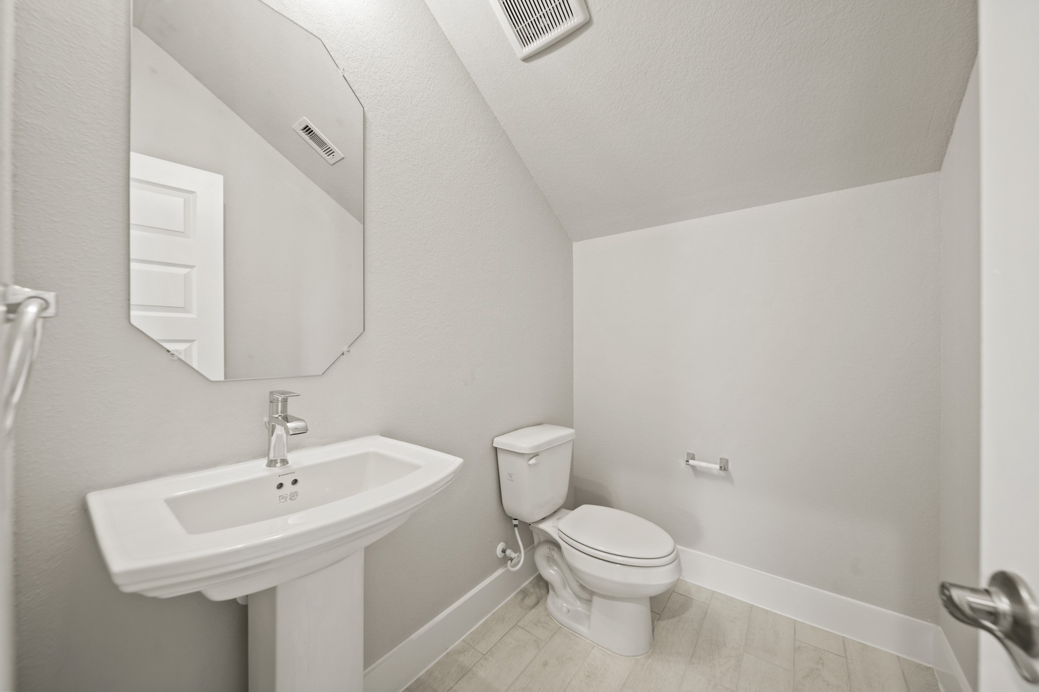 409 Inner Cove Lane Waller, TX 77484 - Photo 16 of 46 a bathroom with a toilet a sink and mirror