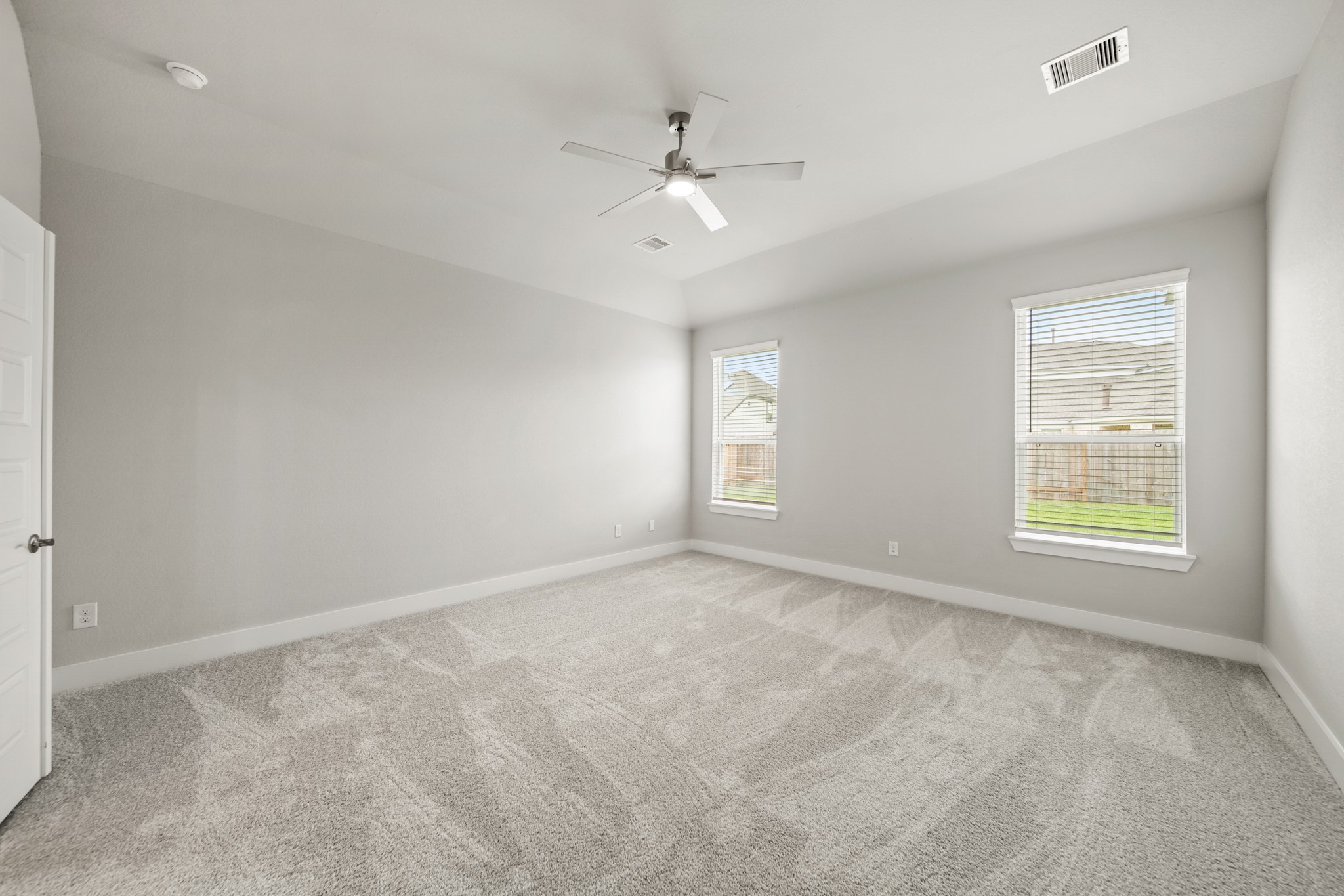 409 Inner Cove Lane Waller, TX 77484 - Photo 17 of 46 an empty room with windows and ceiling fan