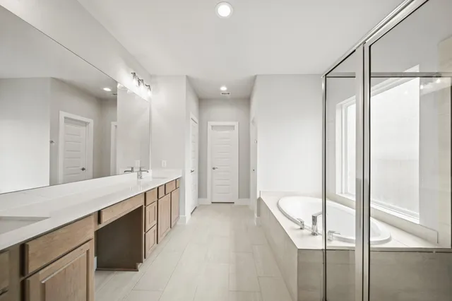 a large bathroom with a double vanity sink and a mirror