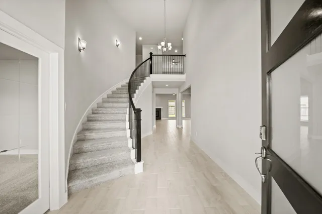 a view of entryway and hall with wooden floor