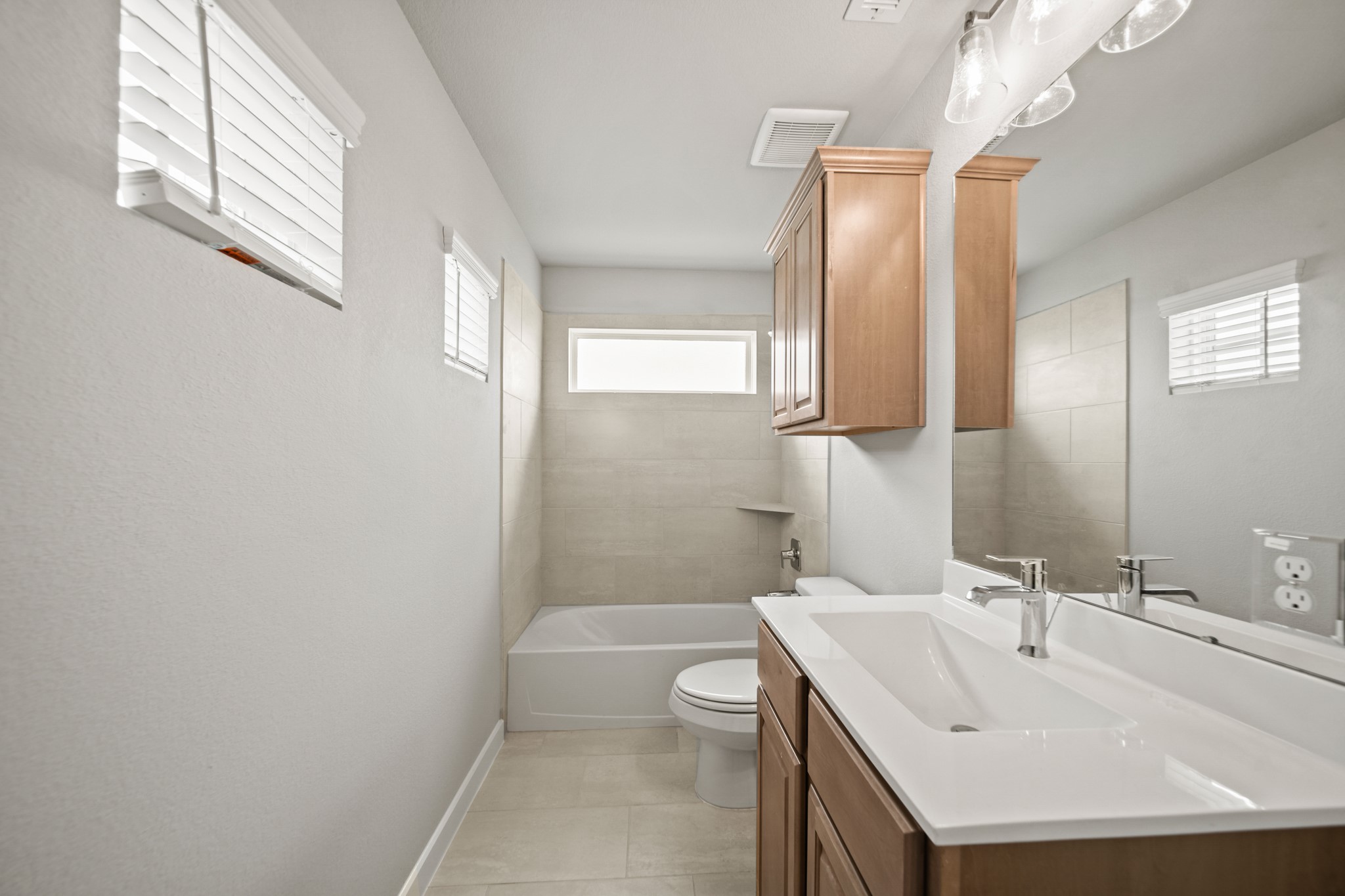 409 Inner Cove Lane Waller, TX 77484 - Photo 23 of 46 a bathroom with a sink a toilet a mirror and shower