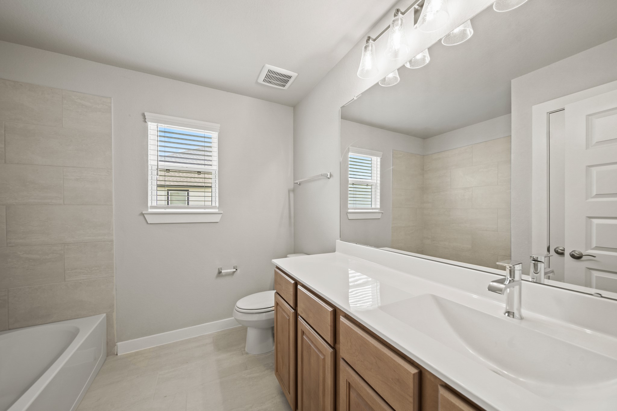 409 Inner Cove Lane Waller, TX 77484 - Photo 26 of 46 a bathroom with a sink a toilet and shower