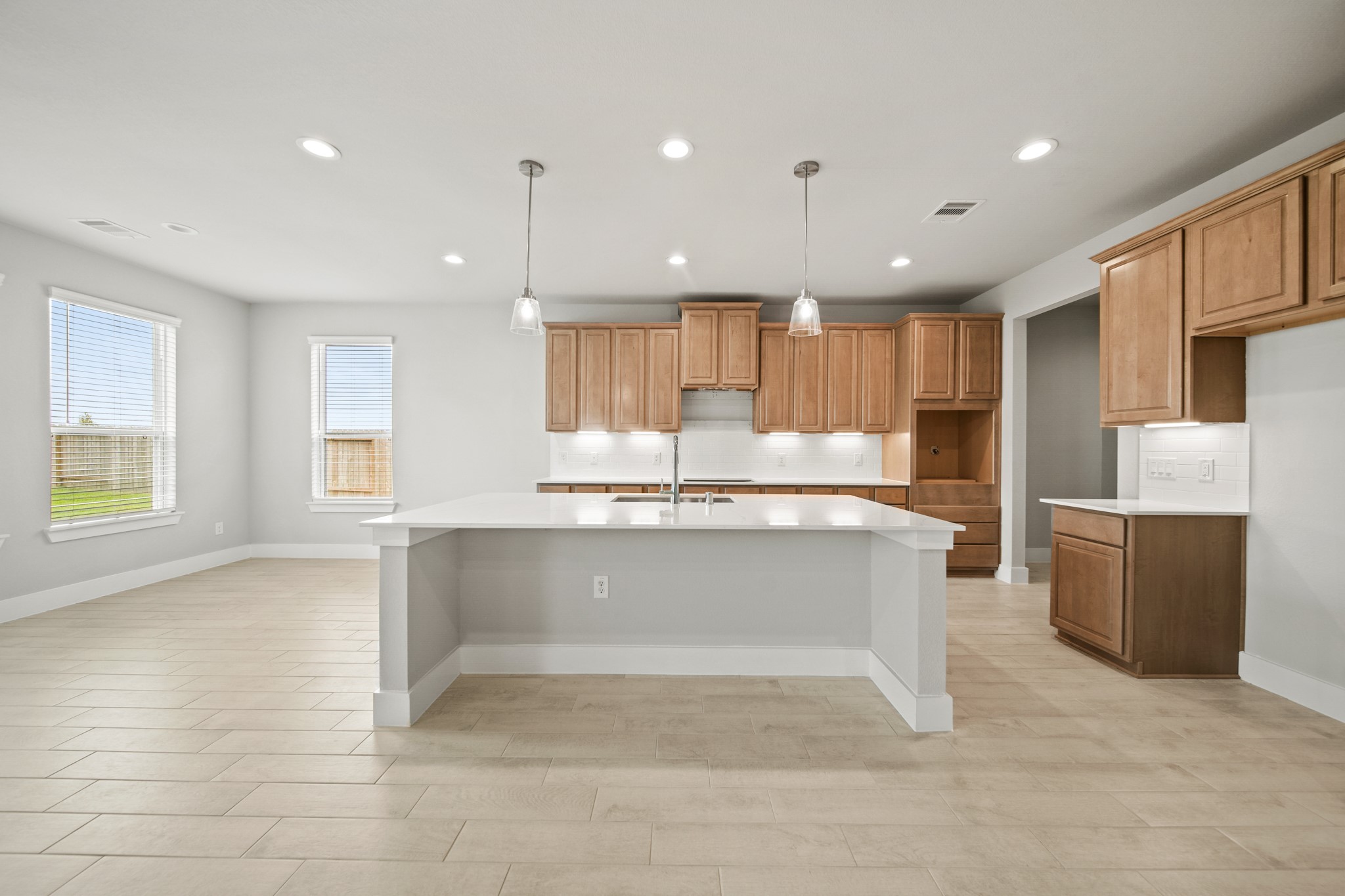 409 Inner Cove Lane Waller, TX 77484 - Photo 3 of 46 a large kitchen with kitchen island a sink stainless steel appliances and cabinets