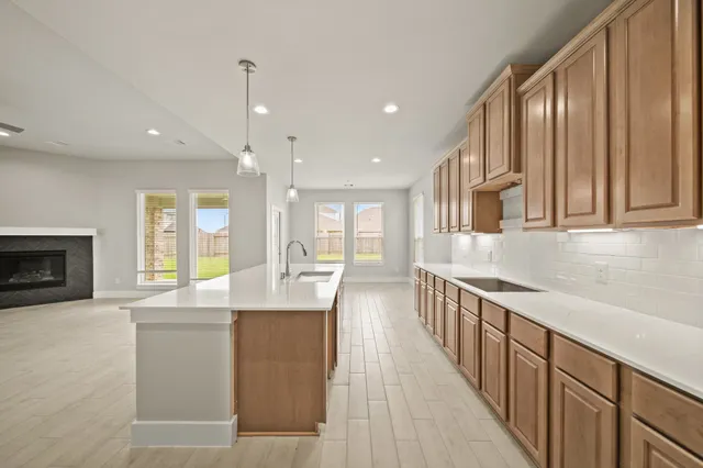 an open kitchen with a sink and dishwasher with a large window