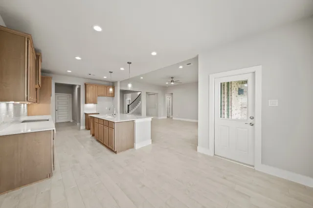 a large kitchen with a large counter top and stainless steel appliances