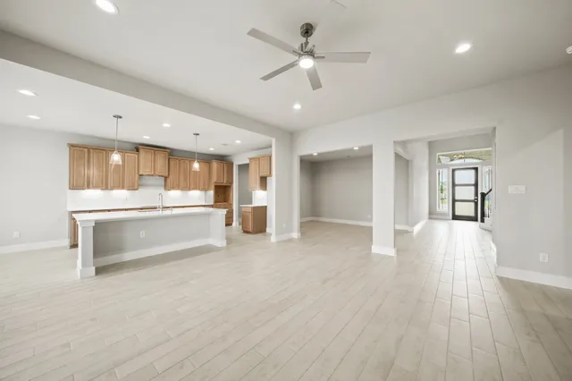 a view of large kitchen with a sink and refrigerator