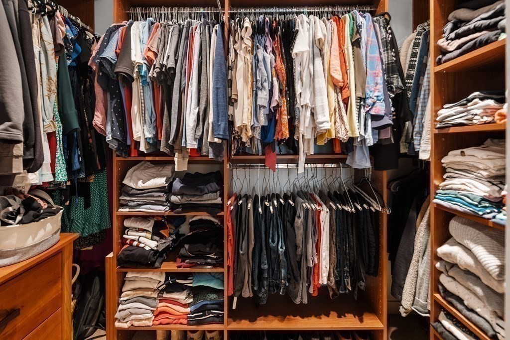 80 Broad Street, Unit 902 Boston, MA 02110 - Photo 12 of 30 a view of walk in closet with clothes and shoes