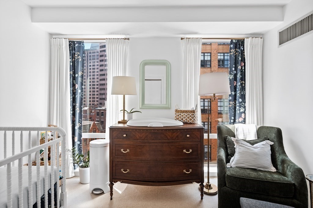 80 Broad Street, Unit 902 Boston, MA 02110 - Photo 13 of 30 a room with a dresser and a window