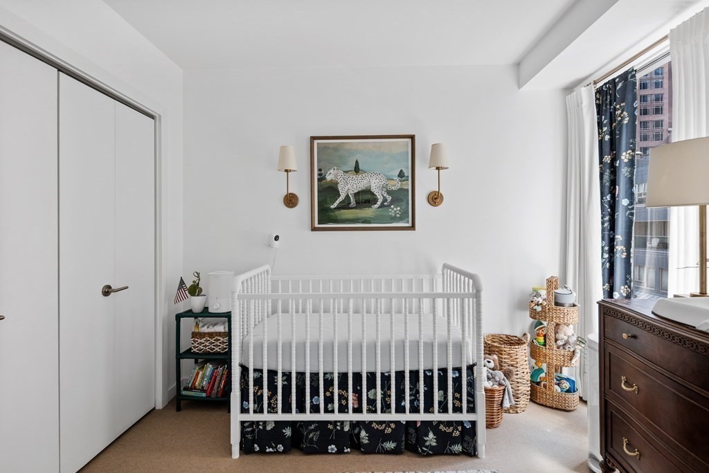 80 Broad Street, Unit 902 Boston, MA 02110 - Photo 14 of 30 a bedroom with a bed and a window