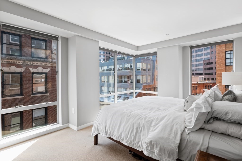 80 Broad Street, Unit 902 Boston, MA 02110 - Photo 7 of 30 a bedroom with a bed and a large window