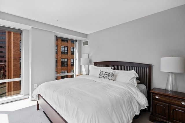 a bedroom with bed and window