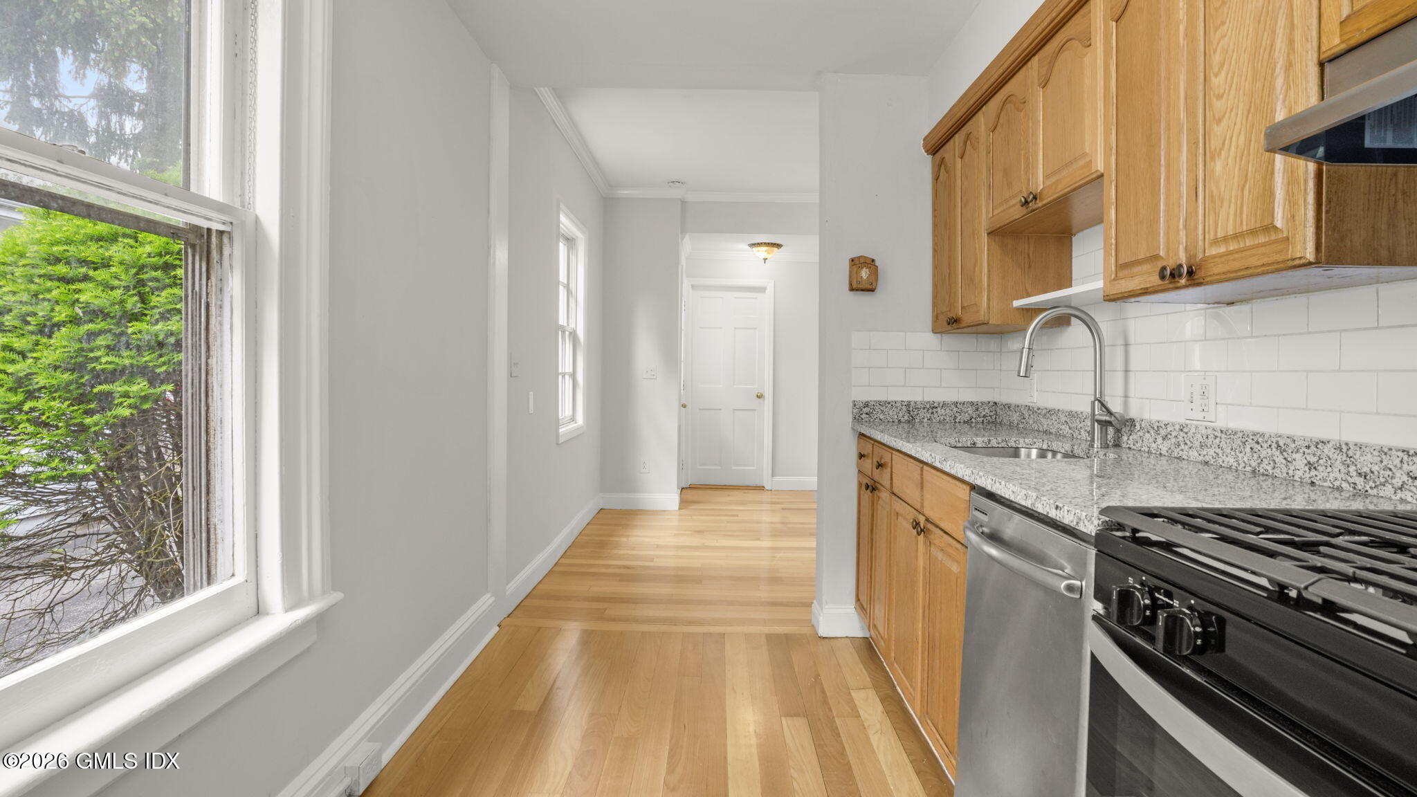 43 Church Street, Unit 1 Greenwich, CT 06830 - Photo 8 of 17 a kitchen with granite countertop a sink and a stove top oven