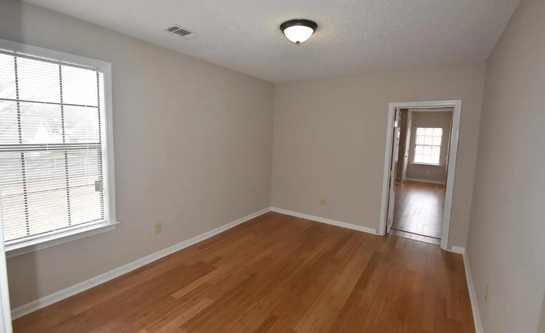7605 Reese Road Memphis, TN 38133 - Photo 5 of 11 an empty room with wooden floor and windows