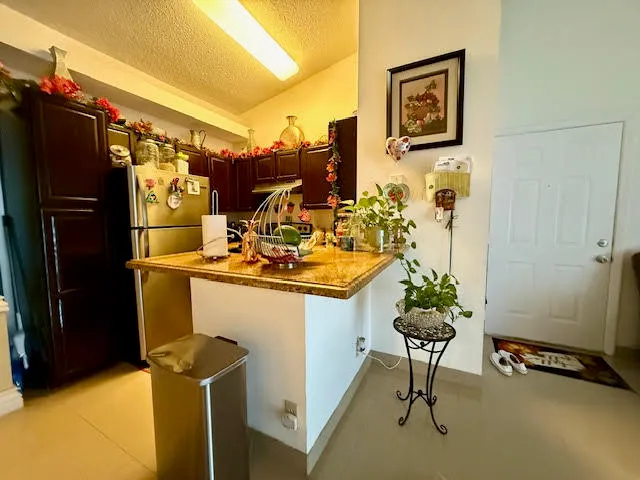 a kitchen with a refrigerator and a stove