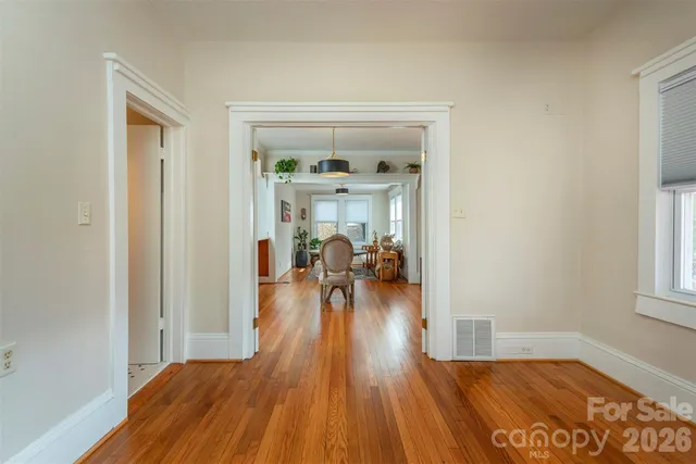 a view of a living room and a wooden floor