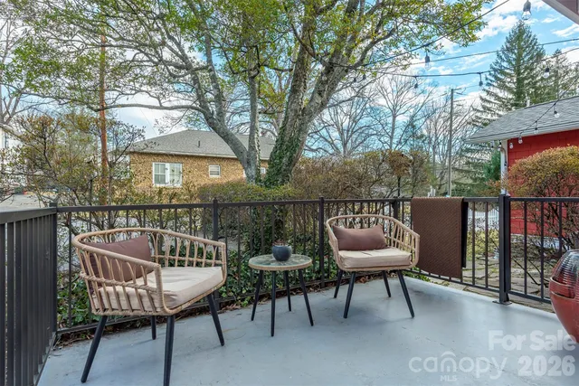 a balcony with a table and chairs