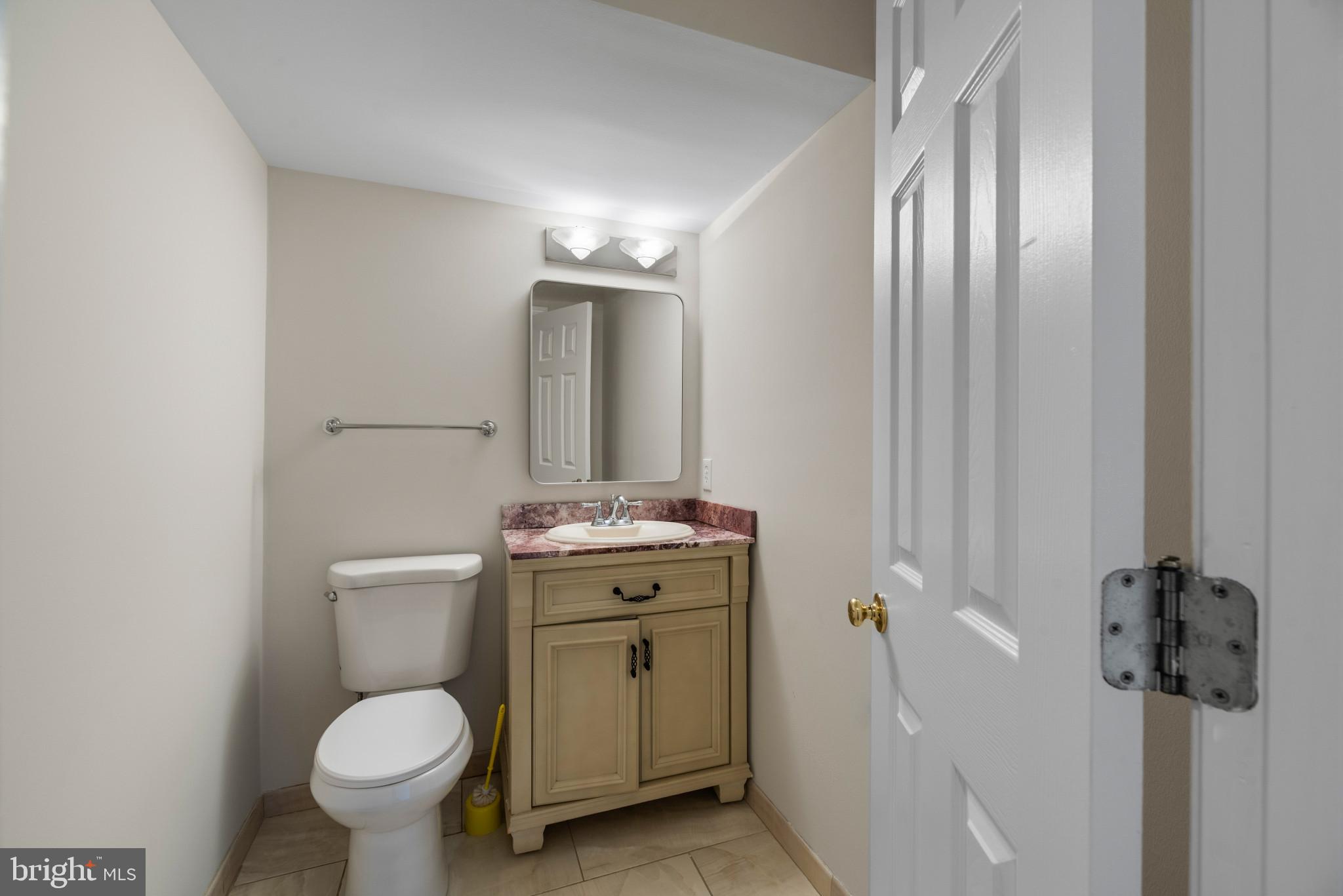5929 Deale Beach Road Deale, MD 20751 - Photo 25 of 58 a bathroom with a toilet sink and mirror