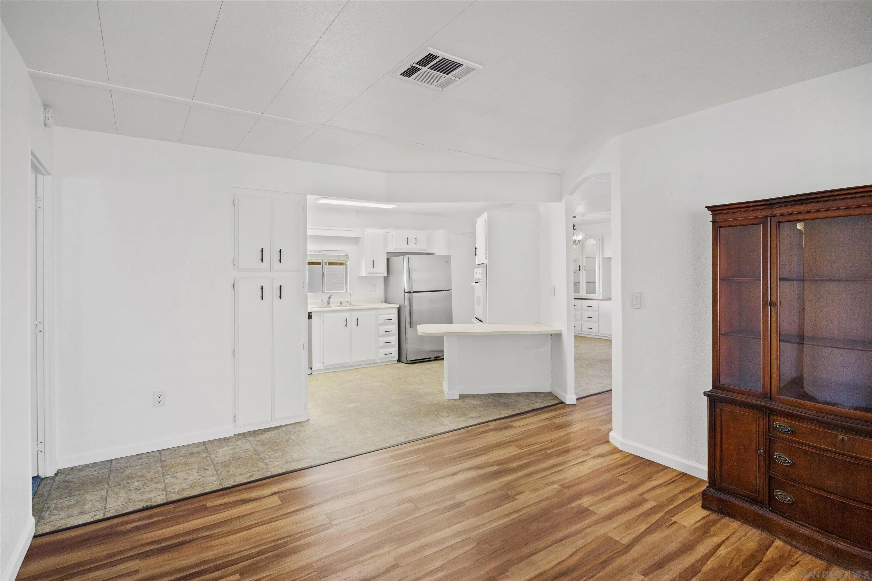 1925 Otay Lakes Road Chula Vista, CA 91913 - Photo 13 of 27 a view of a kitchen with wooden floor and a refrigerator