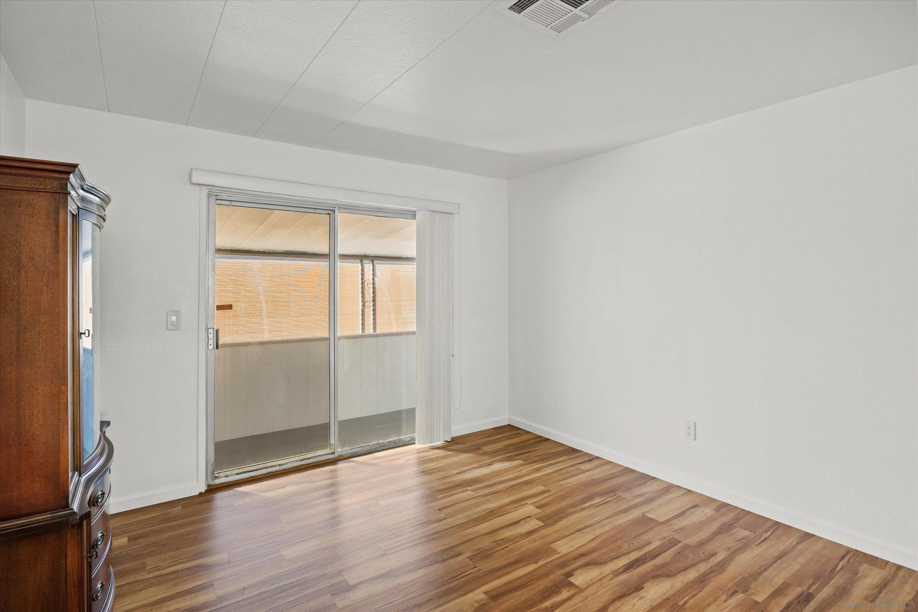 1925 Otay Lakes Road Chula Vista, CA 91913 - Photo 14 of 27 an empty room with wooden floor and windows
