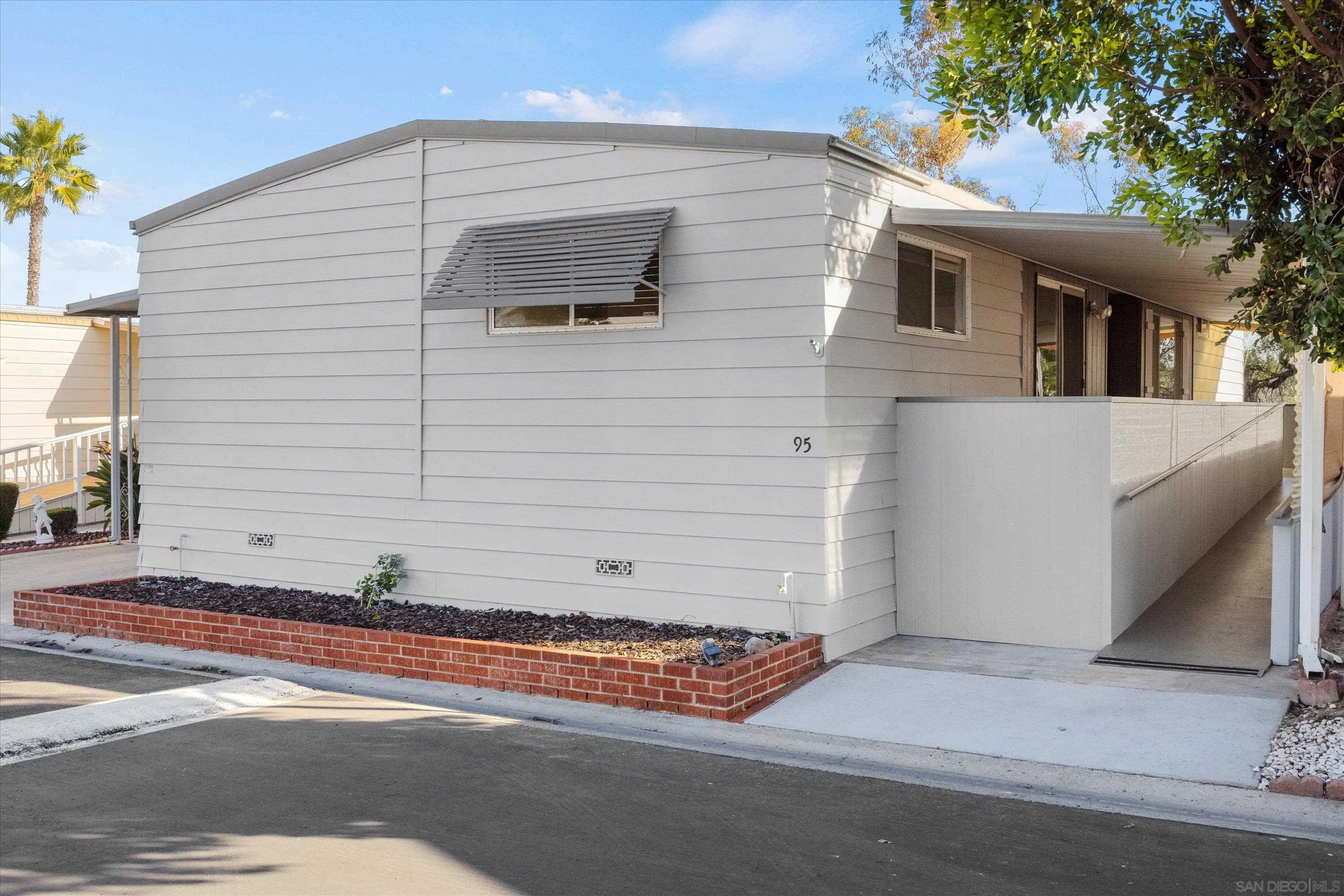 1925 Otay Lakes Road Chula Vista, CA 91913 - Photo 25 of 27 a front view of a house with a yard and garage