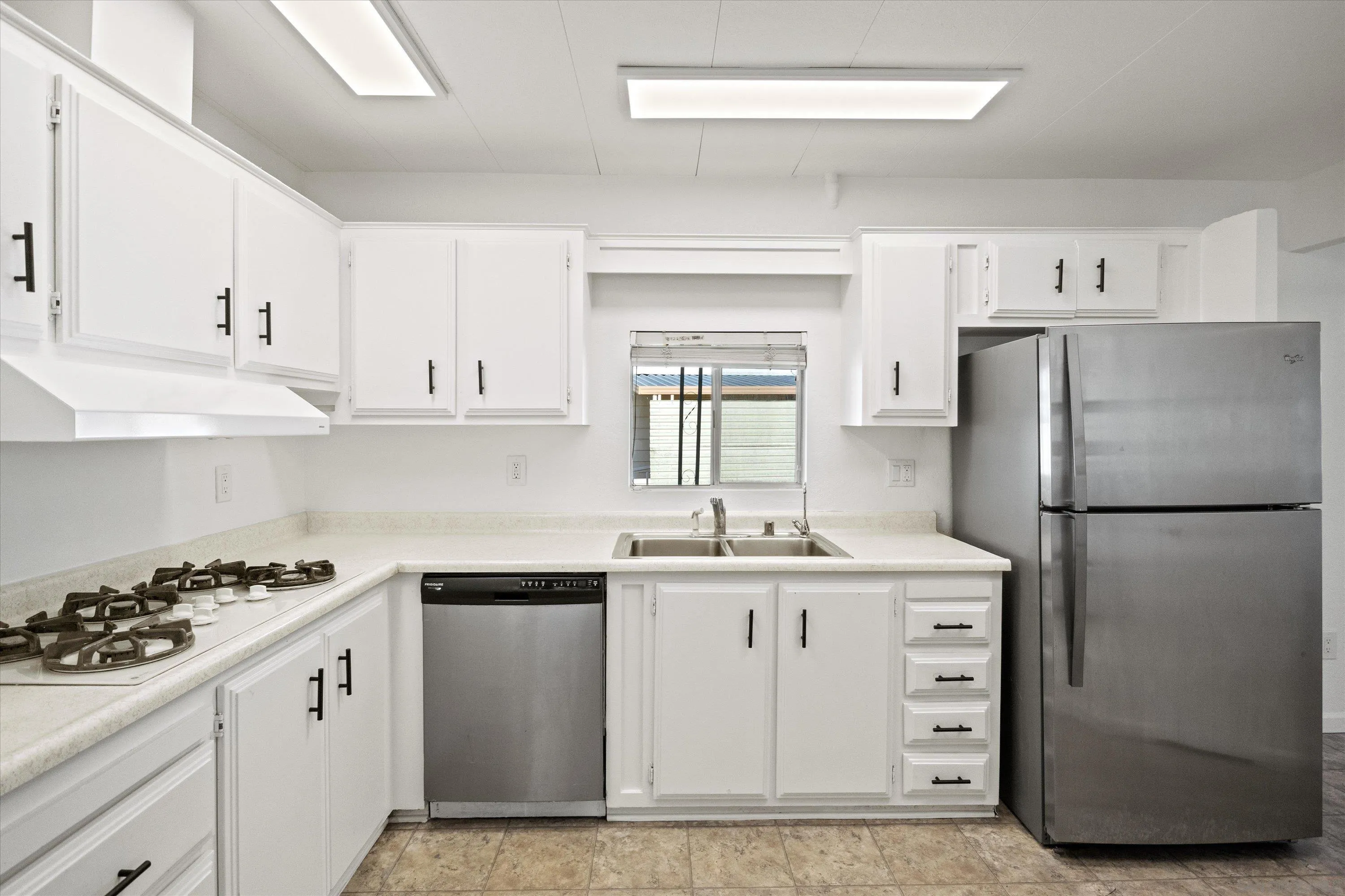 1925 Otay Lakes Road Chula Vista, CA 91913 - Photo 3 of 27 a kitchen with a white stove refrigerator and cabinets