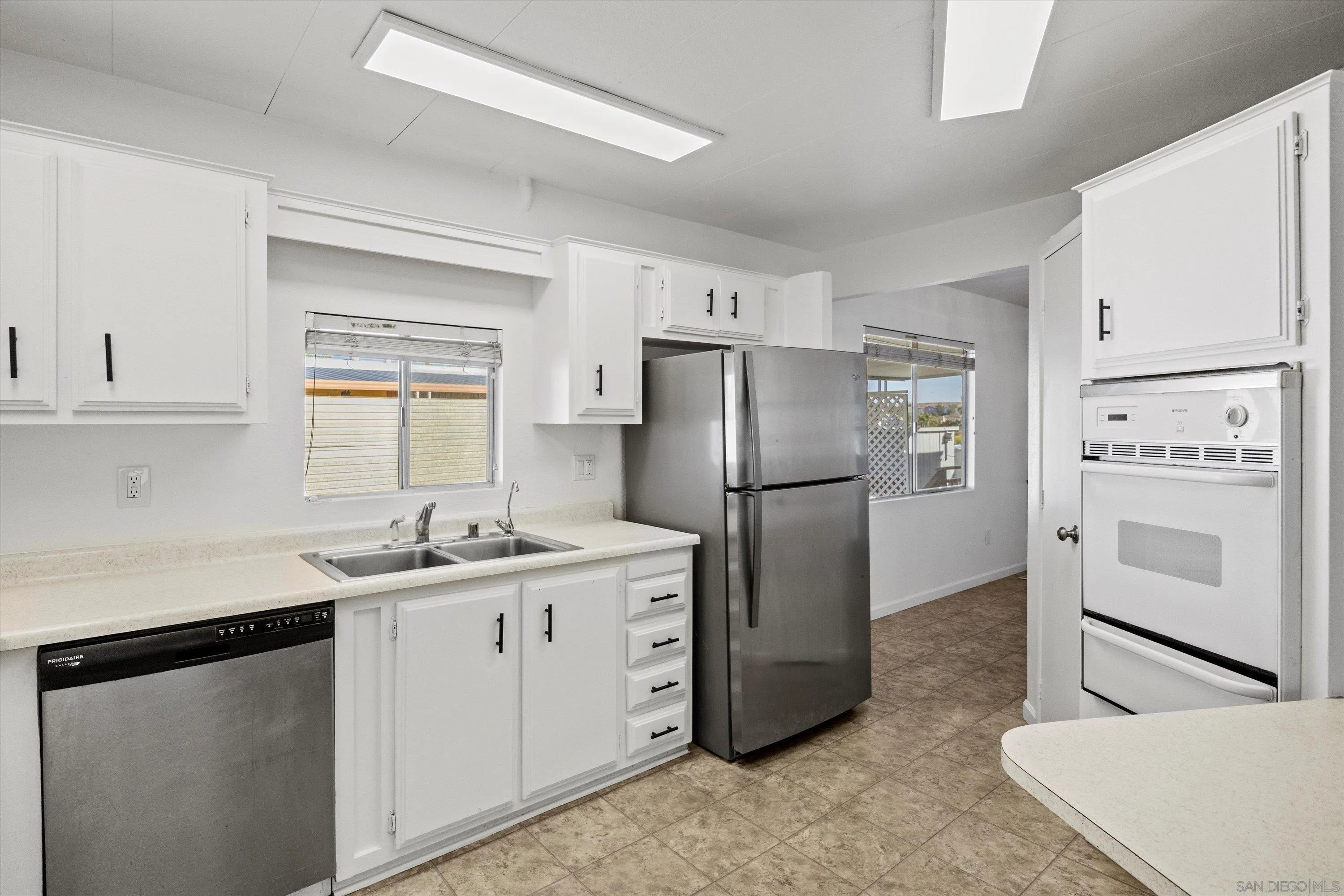 1925 Otay Lakes Road Chula Vista, CA 91913 - Photo 4 of 27 a kitchen with stainless steel appliances a refrigerator sink and cabinets
