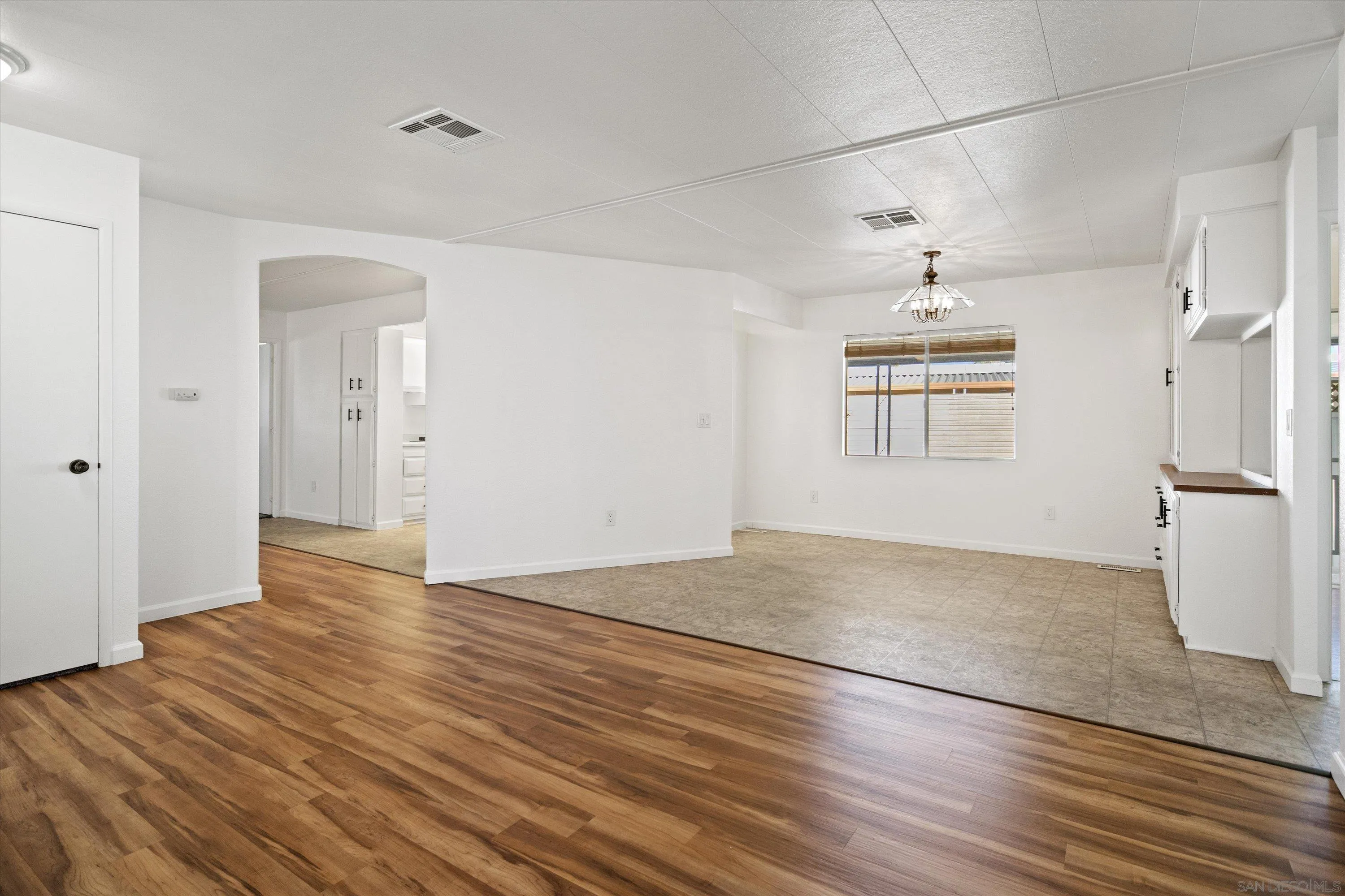 1925 Otay Lakes Road Chula Vista, CA 91913 - Photo 6 of 27 an empty room with wooden floor cabinet and windows