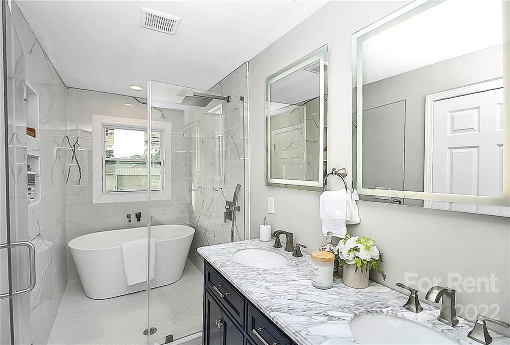 824 South Ridge Avenue, Unit 4 Kannapolis, NC 28083 - Photo 11 of 30 a bathroom with a granite countertop sink and a mirror