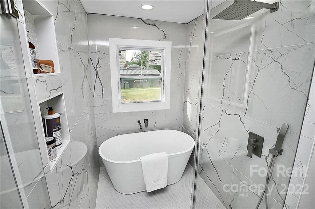 824 South Ridge Avenue, Unit 4 Kannapolis, NC 28083 - Photo 12 of 30 a bathroom with sink shower and mirror