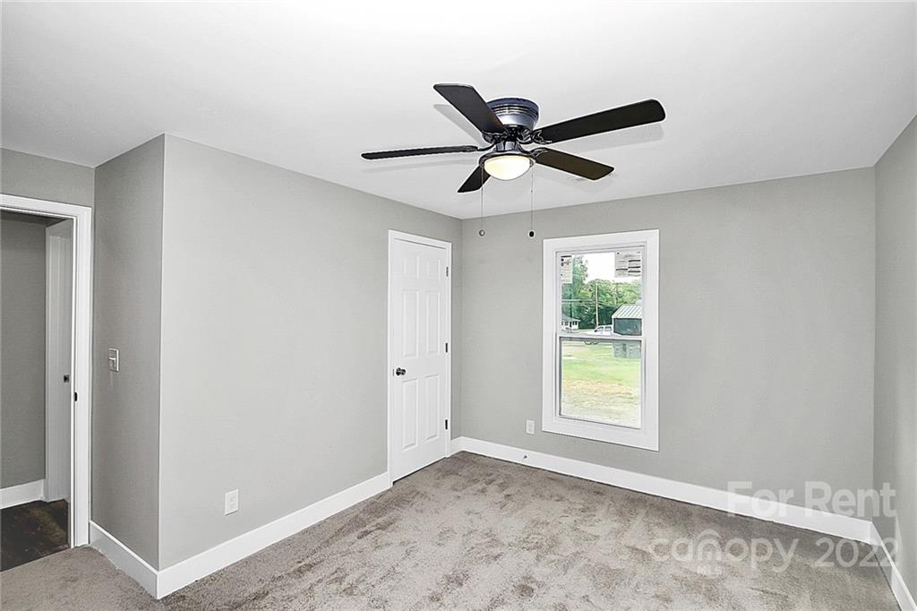 824 South Ridge Avenue, Unit 4 Kannapolis, NC 28083 - Photo 25 of 30 a view of a big room with wooden floor and a ceiling fan