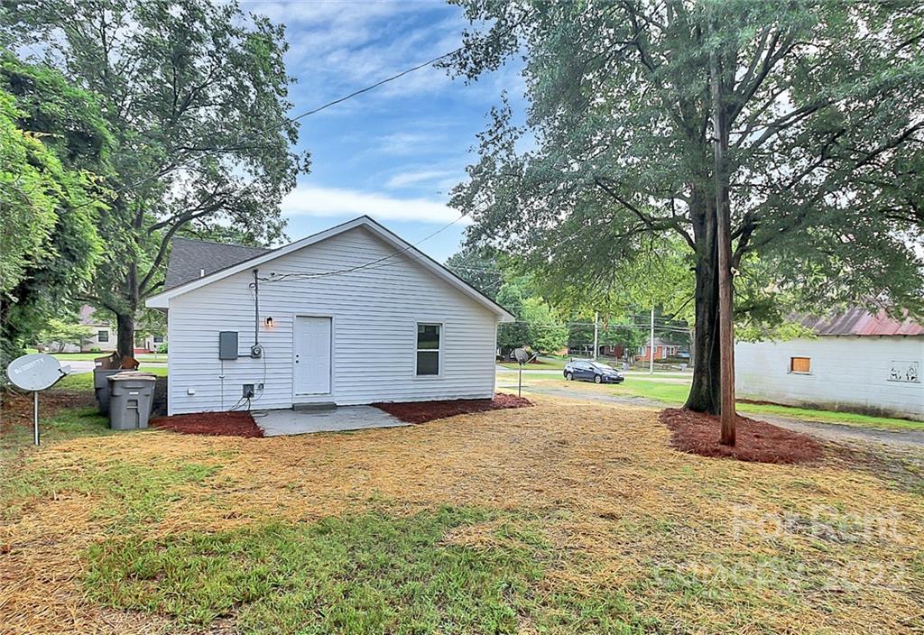 824 South Ridge Avenue, Unit 4 Kannapolis, NC 28083 - Photo 26 of 30 a view of a house with a yard and large tree
