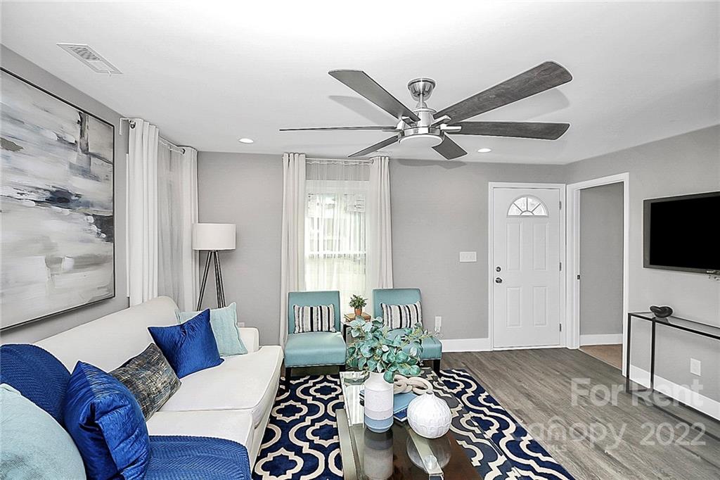 824 South Ridge Avenue, Unit 4 Kannapolis, NC 28083 - Photo 6 of 30 a living room with furniture a flat screen tv and a table