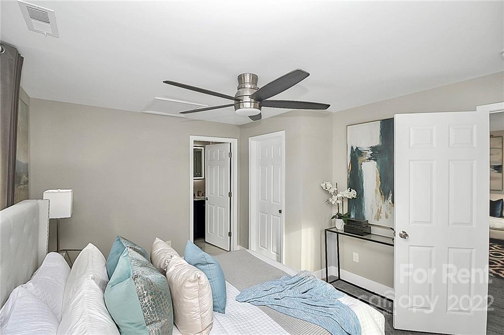 824 South Ridge Avenue, Unit 4 Kannapolis, NC 28083 - Photo 9 of 30 a bedroom with a bed and a chandelier