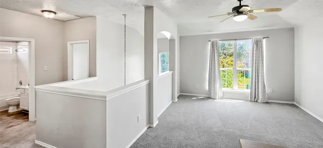 a view of hallway with window and a chandelier