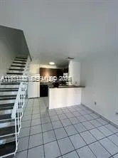 a view of kitchen with microwave and cabinets