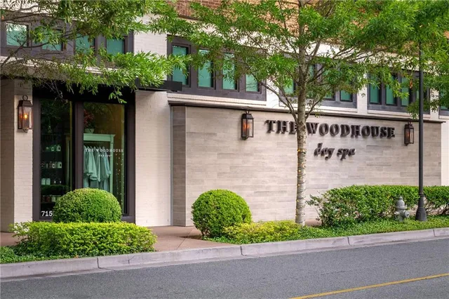 an aerial view of a city with lots of residential buildings ocean and mountain view in back
