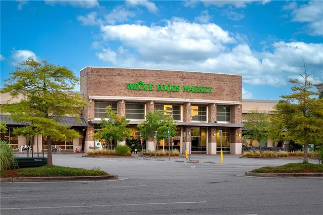 a front view of building with yard and outdoor seating