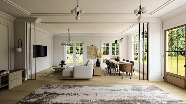 a living room with furniture large window and a table