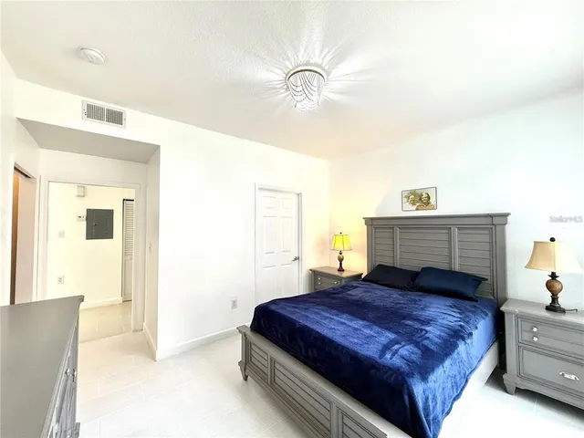 a bedroom with a bed and a chandelier