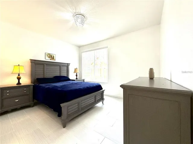 a bedroom with a bed and a dresser