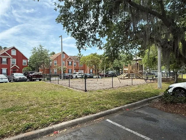 a street view with tall buildings and a park