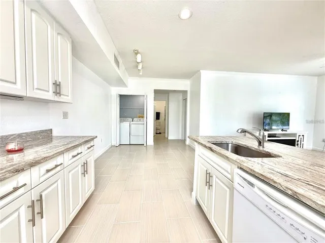 a kitchen with stainless steel appliances granite countertop a sink and cabinets