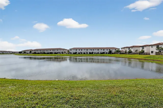 an aerial view of a house with swimming pool and furniture