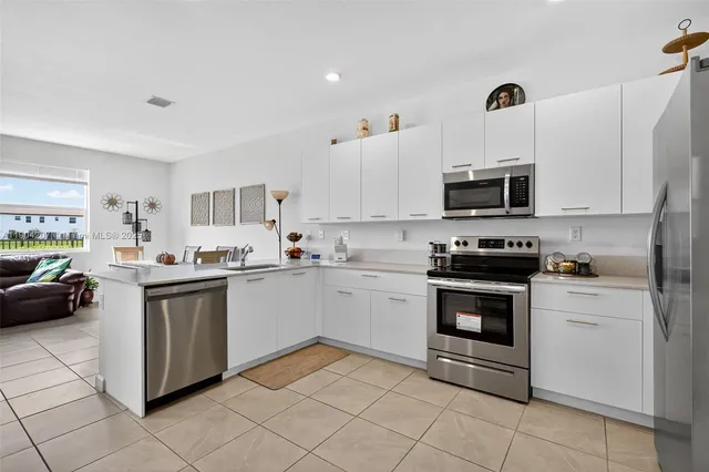 a kitchen with cabinets and stainless steel appliances