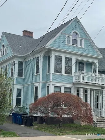 a front view of residential houses with yard and green space