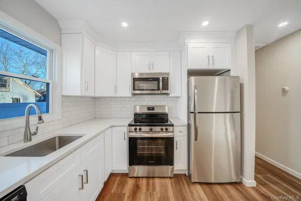 a kitchen with a stove a refrigerator and a sink