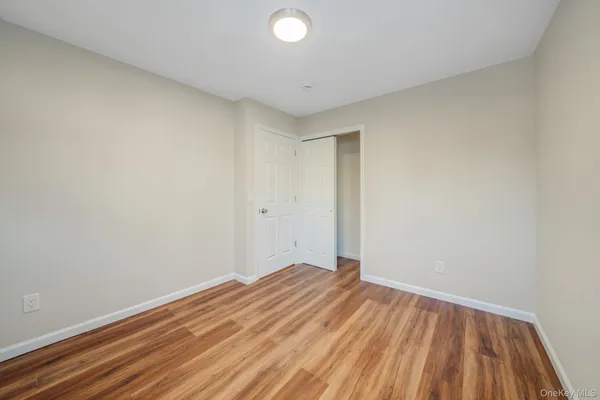 a view of room with wooden floor